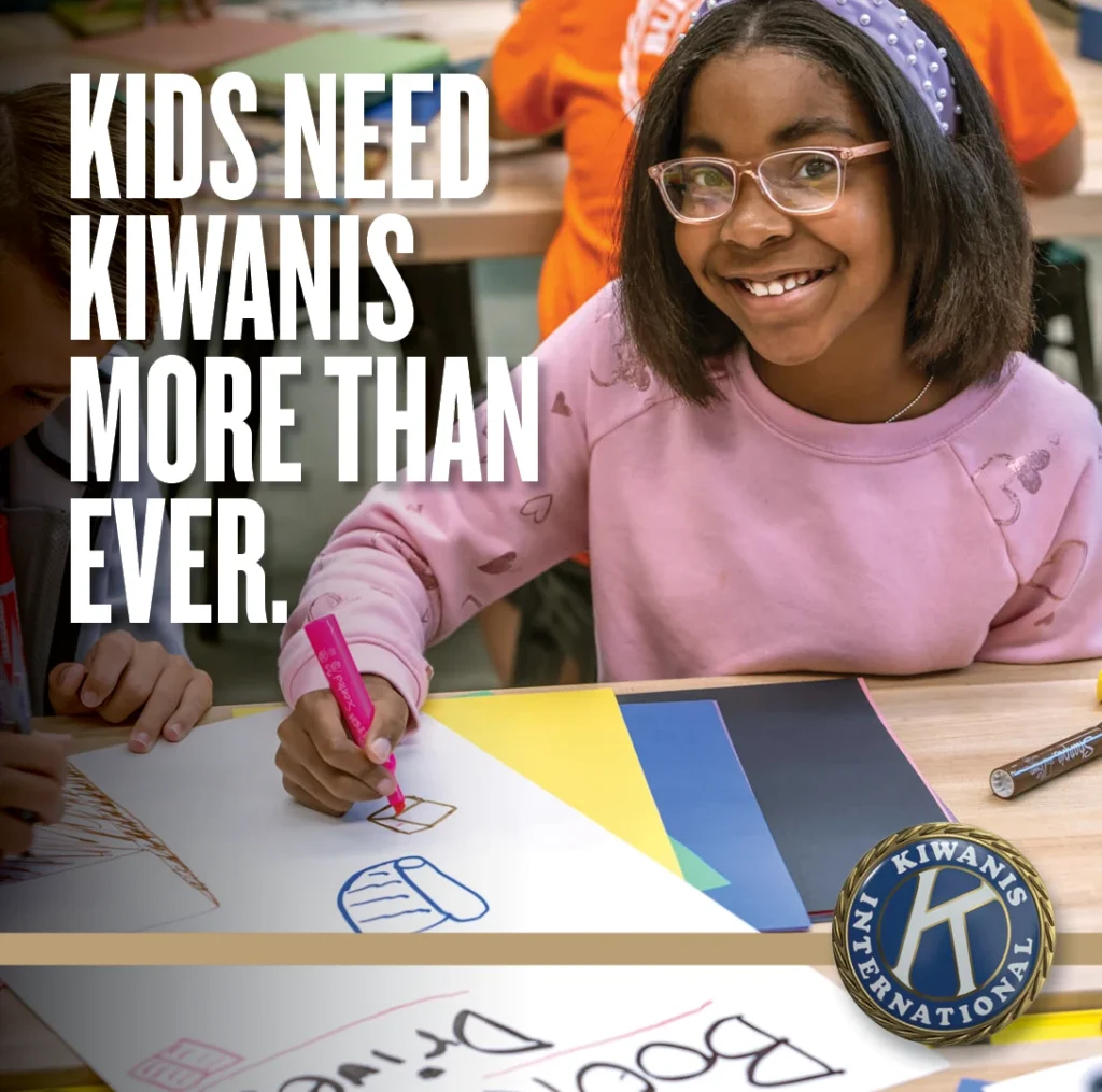 Child creating artwork with the message: Kids need Kiwanis more than ever.