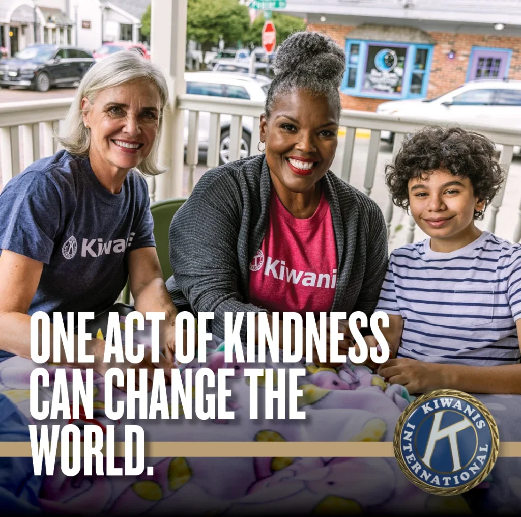 Kiwanis members and a child with the message: One act of kindness can change the world.